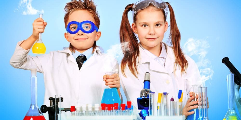 Two children making science experiments. Education.
